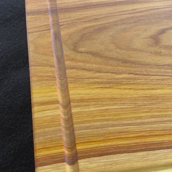 video showcasing an upclose version of the of the cutting board made from canary wood. 
