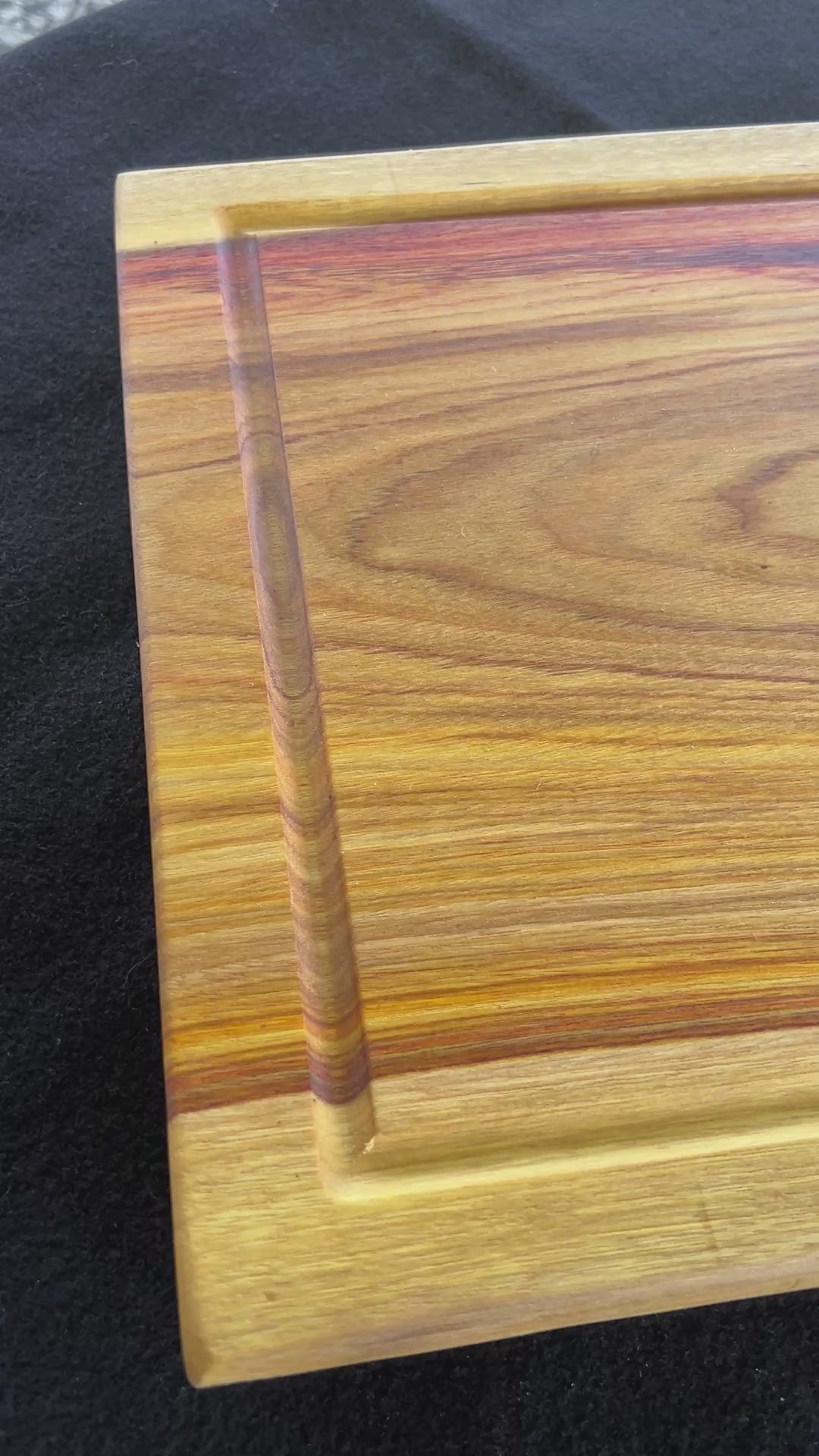 video showcasing an upclose version of the of the cutting board made from canary wood. 